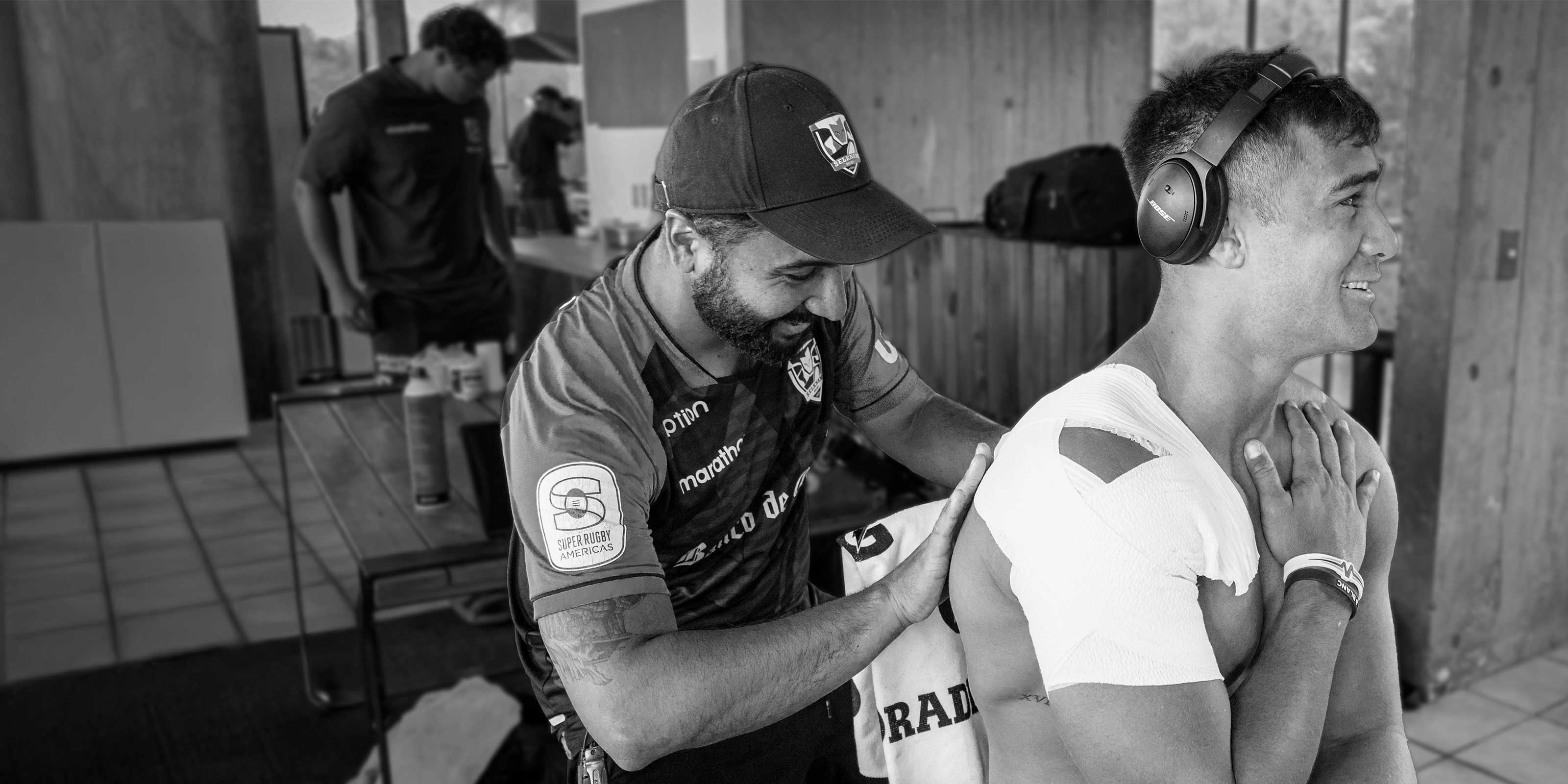 Chile Rugby Physio applying tape to shoulder of a player