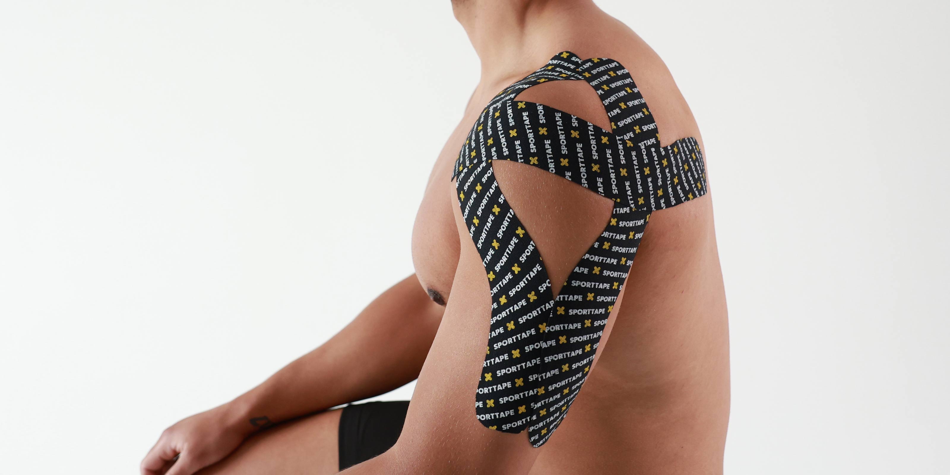 Person wearing Kinesiology Tape on the Shoulder and down the arm, against a white background
