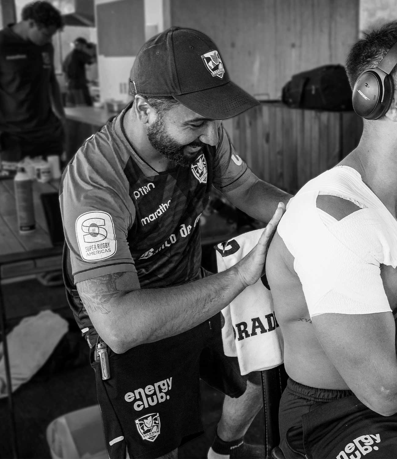 Chile Rugby Physio applying tape to shoulder of a player