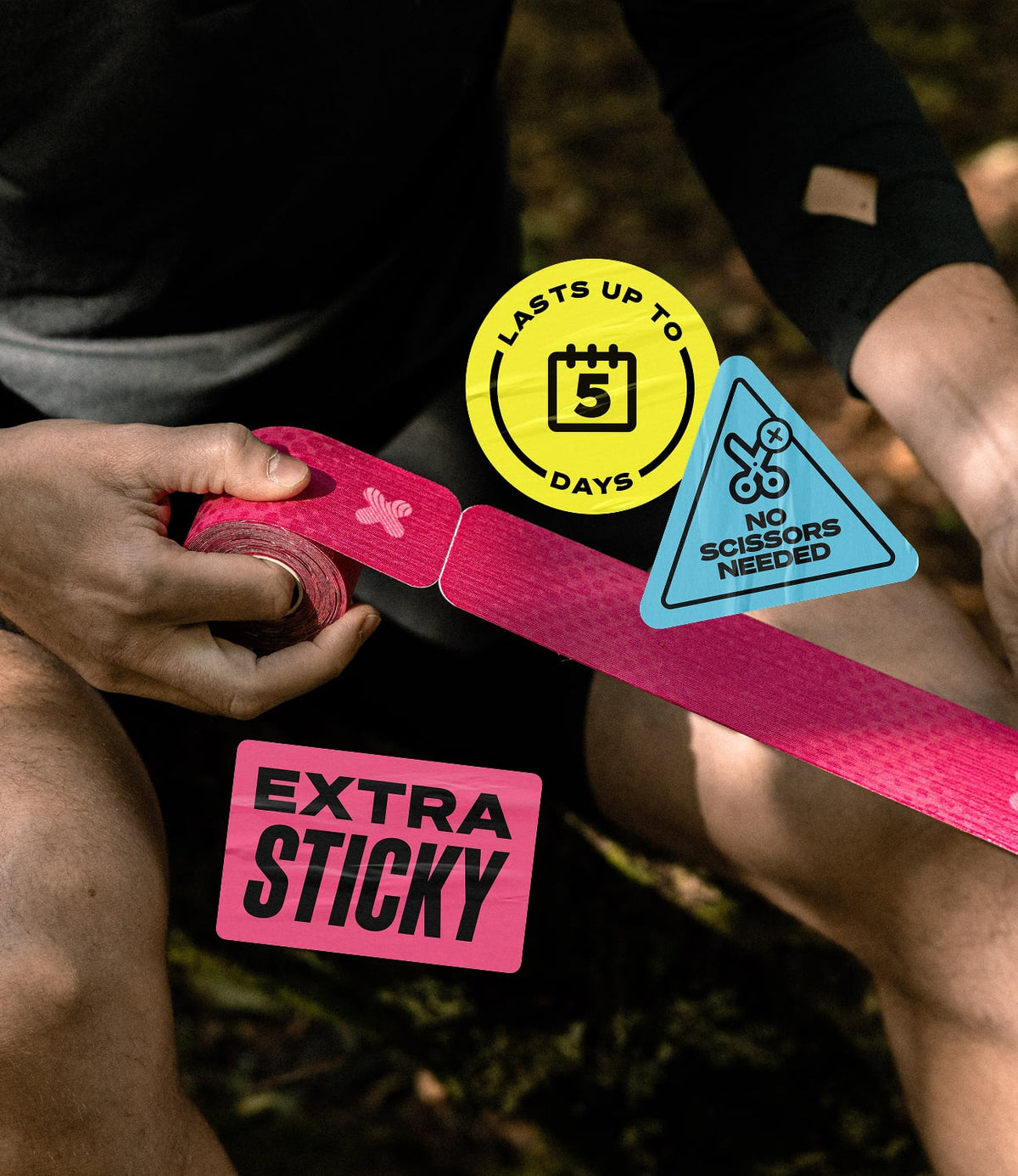 A person outdoors holds a roll of bright pink kinesiology tape, with the tape laid out across their lap. Three product feature stickers are shown: a yellow circle reading 'LASTS UP TO 5 DAYS' and a blue triangle reading 'NO SCISSORS NEEDED,' plus a pink rectangle reading 'EXTRA STICKY.