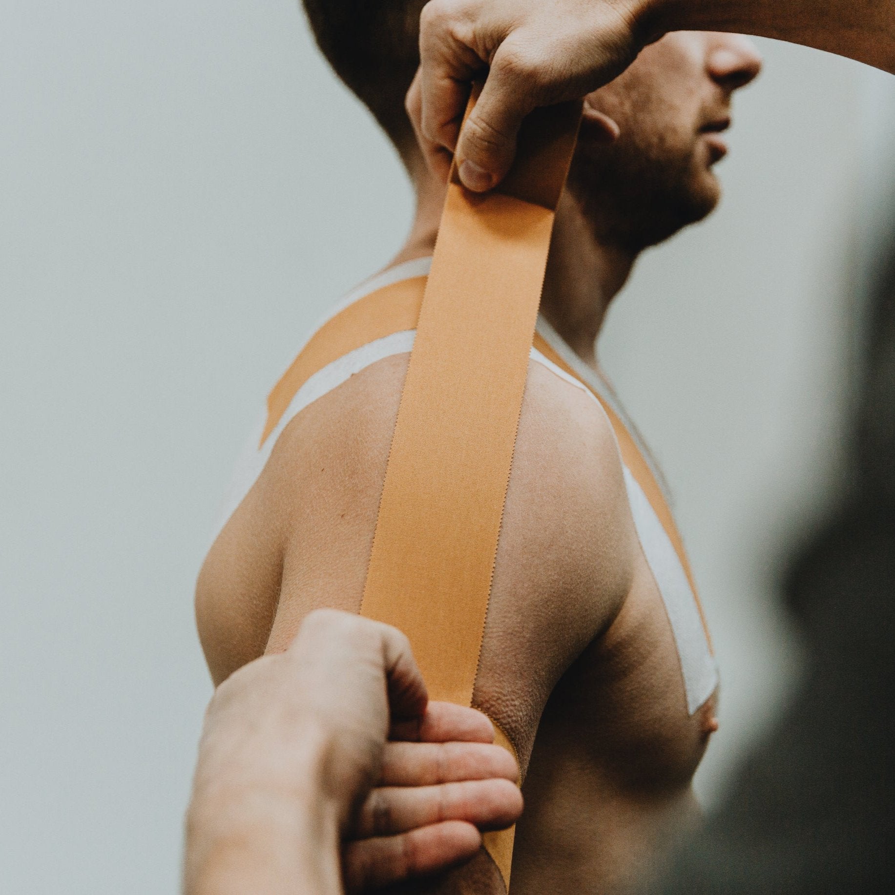 Zinc Oxide Tan Tape applied to the shoulder